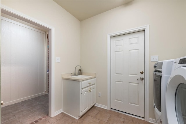 clothes washing area featuring cabinets, washer / dryer, light tile patterned floors, and sink