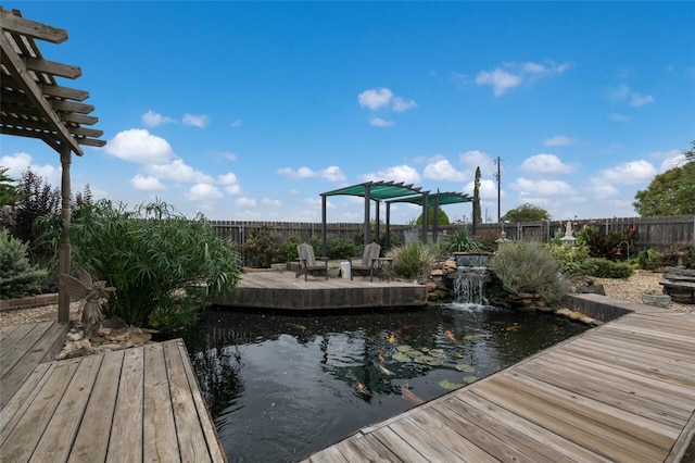 view of dock with a pergola and a wooden deck