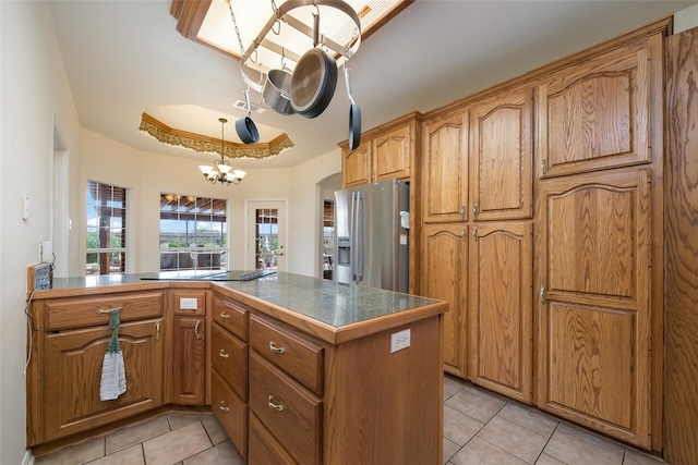 kitchen featuring kitchen peninsula, black electric stovetop, light tile patterned floors, an inviting chandelier, and stainless steel fridge with ice dispenser