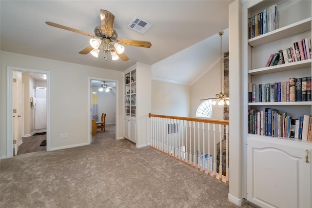 interior space with light colored carpet, built in features, and lofted ceiling