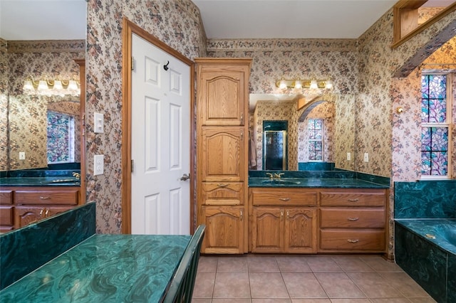 bathroom featuring tile patterned floors, a tub to relax in, and vanity