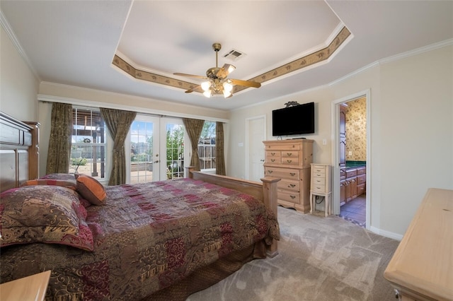 carpeted bedroom with french doors, ensuite bathroom, a raised ceiling, and ceiling fan