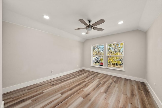 unfurnished room with ceiling fan, light hardwood / wood-style floors, and lofted ceiling