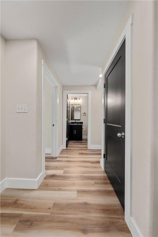 corridor with light wood-type flooring