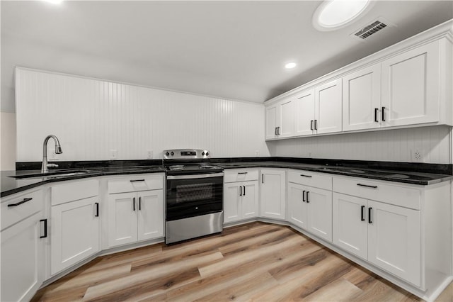 kitchen featuring white cabinets, sink, light hardwood / wood-style flooring, and stainless steel electric range