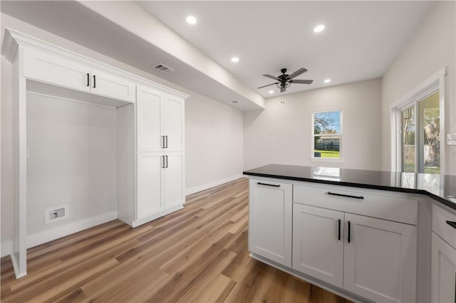 kitchen featuring ceiling fan, white cabinets, and light wood-type flooring