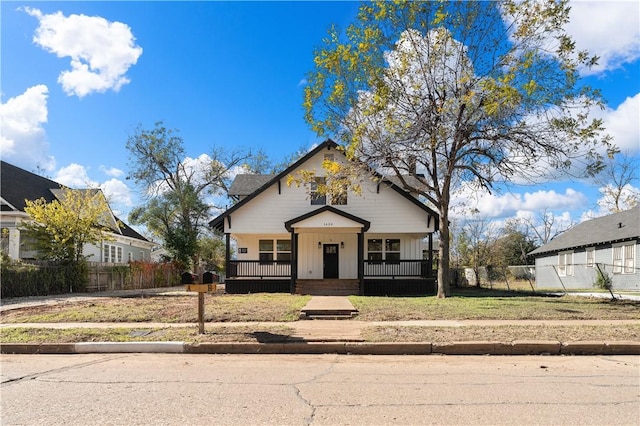 bungalow featuring a front lawn and a porch