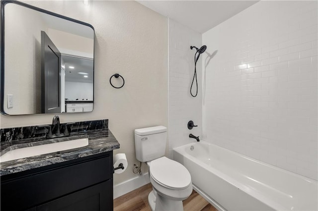 full bathroom with toilet, vanity, tiled shower / bath combo, and hardwood / wood-style flooring