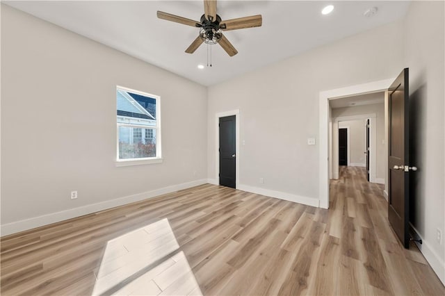 unfurnished bedroom with ceiling fan and light hardwood / wood-style flooring