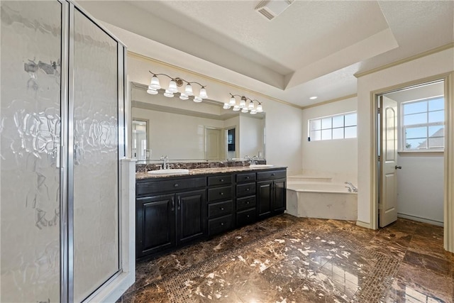 full bathroom with a garden tub, double vanity, a raised ceiling, a sink, and a shower stall