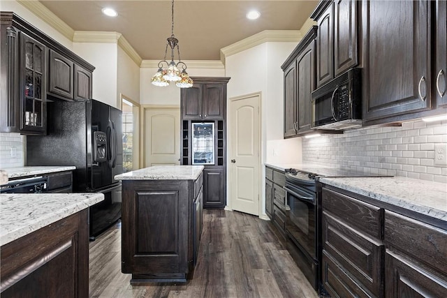 kitchen with dark brown cabinetry, dark wood-style floors, ornamental molding, black appliances, and pendant lighting