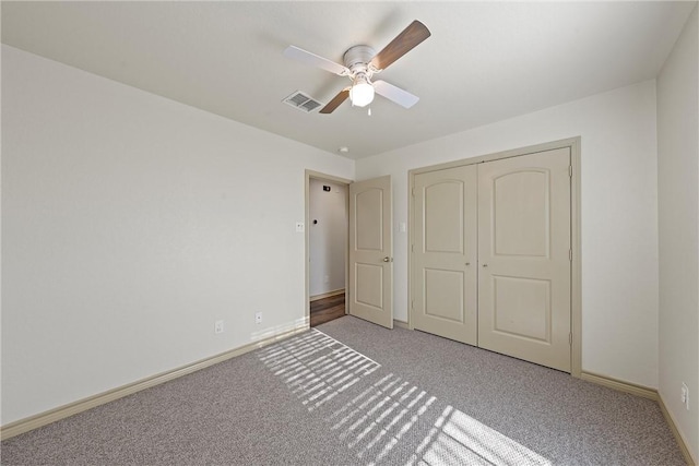 unfurnished bedroom with a closet, baseboards, visible vents, and carpet flooring