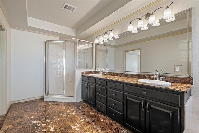 full bath featuring a stall shower, a raised ceiling, visible vents, and a sink