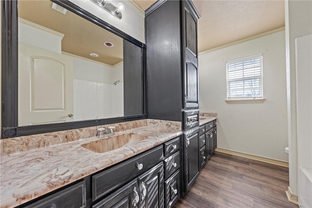 full bath with baseboards, a shower, wood finished floors, and vanity