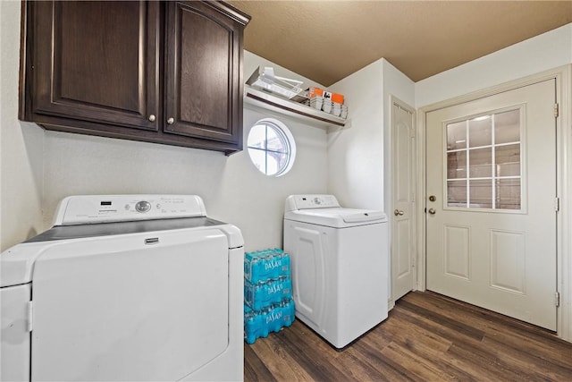 laundry area with cabinet space, dark wood finished floors, and washing machine and clothes dryer