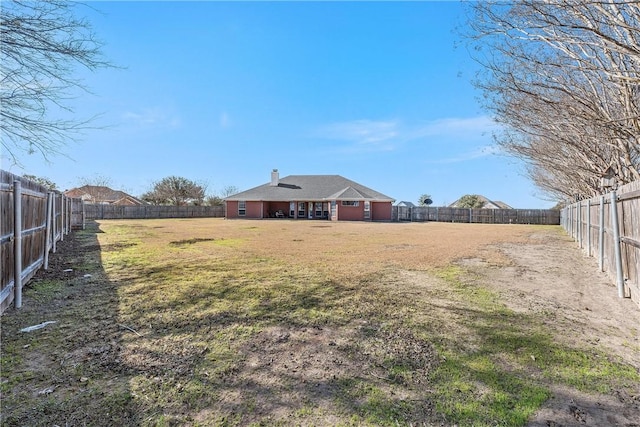 view of yard with a fenced backyard