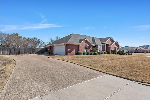 ranch-style home featuring brick siding, a front yard, fence, a garage, and driveway