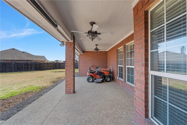 view of patio featuring ceiling fan and fence