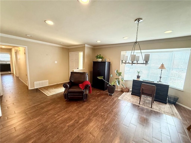 interior space with an inviting chandelier, ornamental molding, and dark hardwood / wood-style flooring