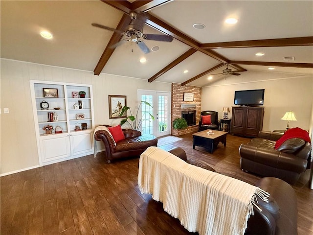 living room with french doors, lofted ceiling with beams, a brick fireplace, dark hardwood / wood-style flooring, and ceiling fan