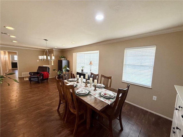 dining room with dark hardwood / wood-style flooring, a notable chandelier, and crown molding