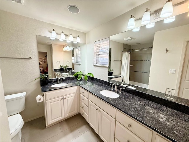 bathroom featuring vanity, a shower with curtain, tile patterned floors, and toilet