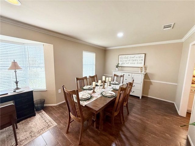 dining space with crown molding, plenty of natural light, and dark hardwood / wood-style flooring