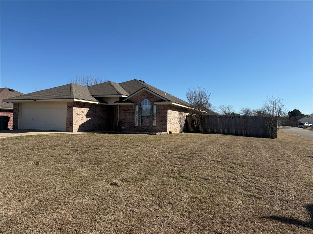 view of front of house with a garage and a front lawn