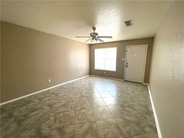 interior space with a textured ceiling and ceiling fan