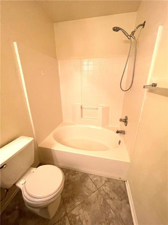 bathroom with toilet and shower / bathtub combination