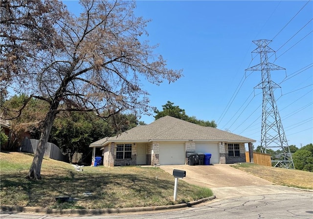 ranch-style house featuring a front yard and a garage