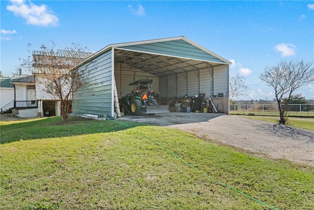 view of outbuilding with a carport and a lawn