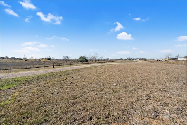 view of yard with a rural view