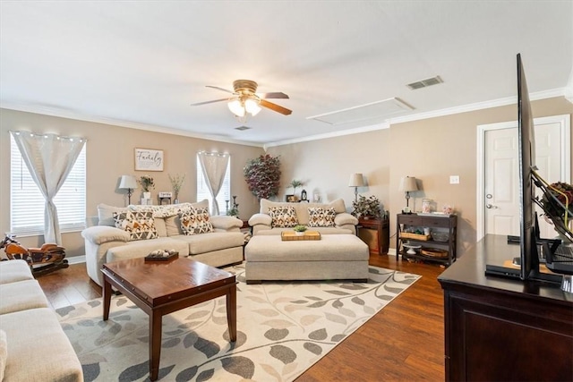 living room with hardwood / wood-style flooring, ceiling fan, and crown molding