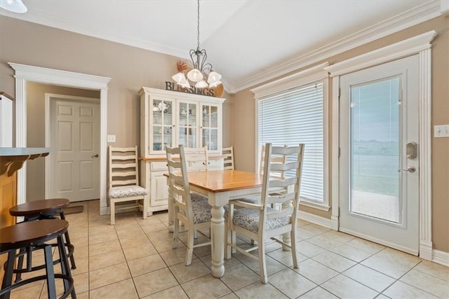 tiled dining area with ornamental molding and a notable chandelier