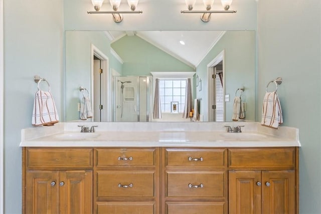 bathroom with crown molding, a shower with door, vanity, and vaulted ceiling