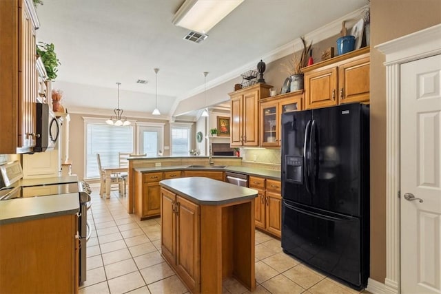 kitchen with kitchen peninsula, appliances with stainless steel finishes, crown molding, pendant lighting, and a center island