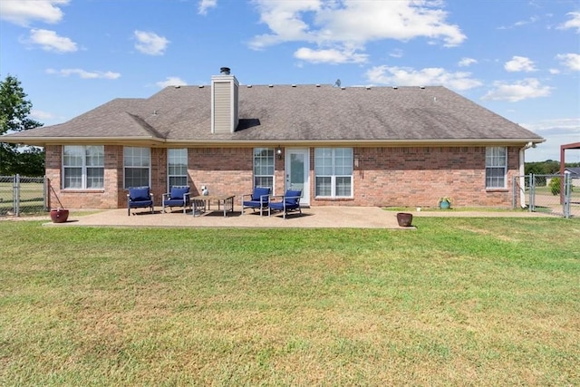 back of house featuring a lawn and a patio