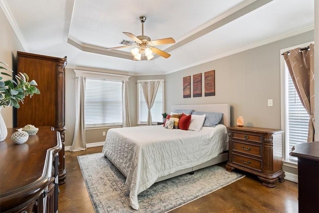 bedroom with a raised ceiling, multiple windows, ornamental molding, and ceiling fan