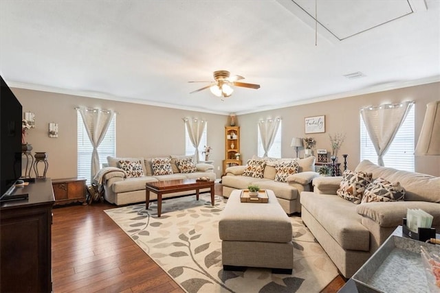 living room with crown molding, dark hardwood / wood-style flooring, and a healthy amount of sunlight