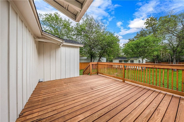 wooden deck featuring a yard