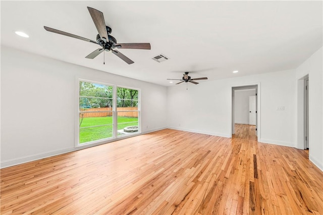 spare room with light hardwood / wood-style flooring and ceiling fan