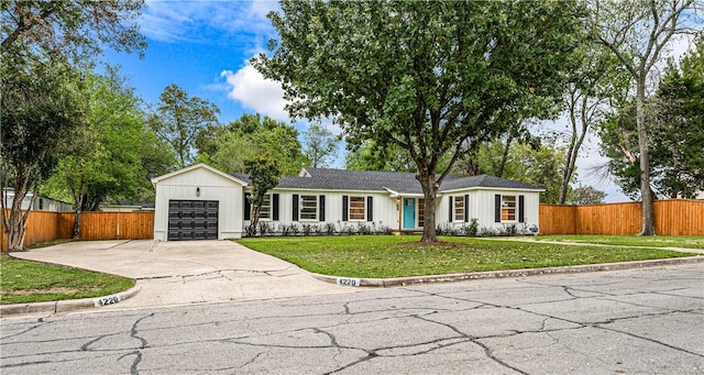 ranch-style home featuring a garage and a front yard