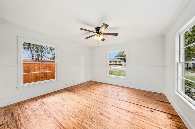 empty room with ceiling fan, ornamental molding, and light hardwood / wood-style flooring