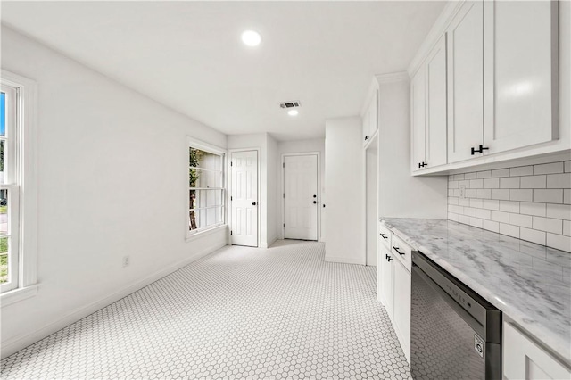 kitchen with white cabinets, decorative backsplash, light stone counters, and dishwasher