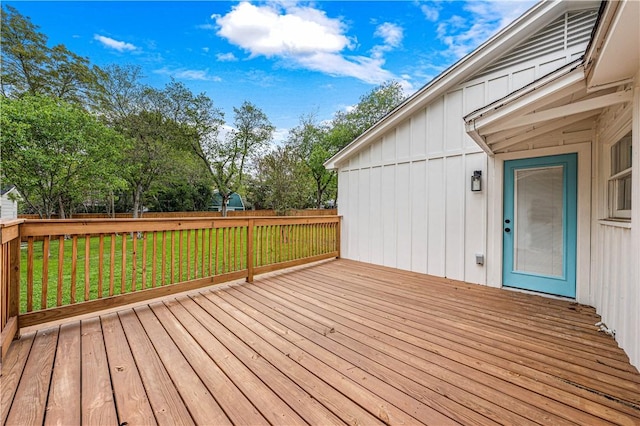 wooden deck featuring a lawn