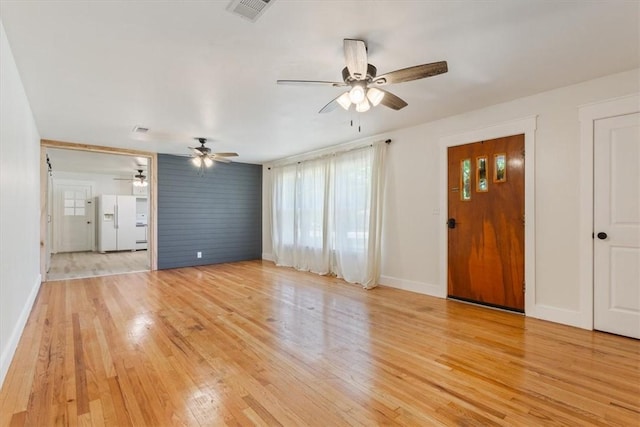 unfurnished living room with ceiling fan and light hardwood / wood-style floors