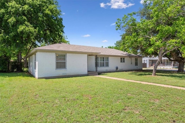 ranch-style home featuring a front lawn