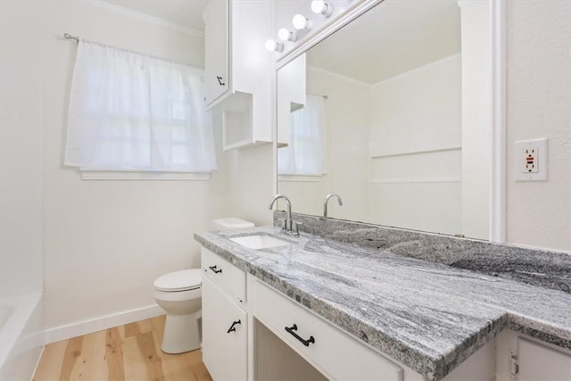 bathroom with vanity, hardwood / wood-style flooring, and toilet