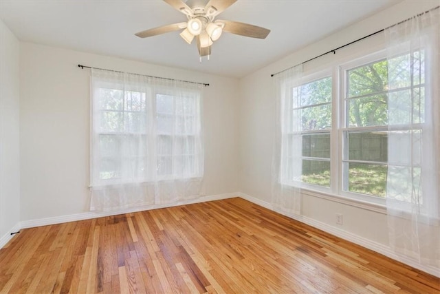 spare room featuring light hardwood / wood-style flooring and ceiling fan